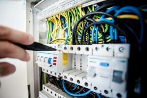 Electrician testing a fuse board for compliance during an EICR inspection