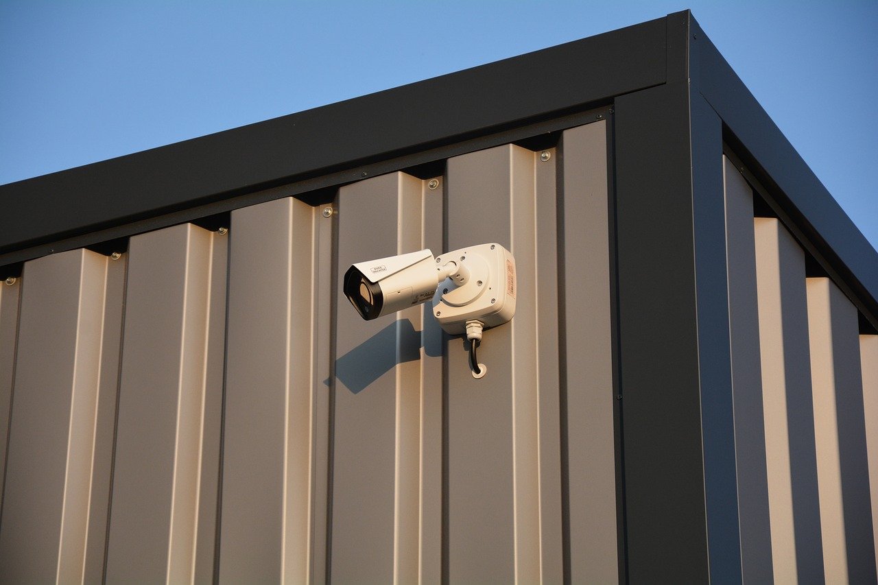 CCTV camera installed on the exterior of a factory unit to enhance security and monitor industrial activity.